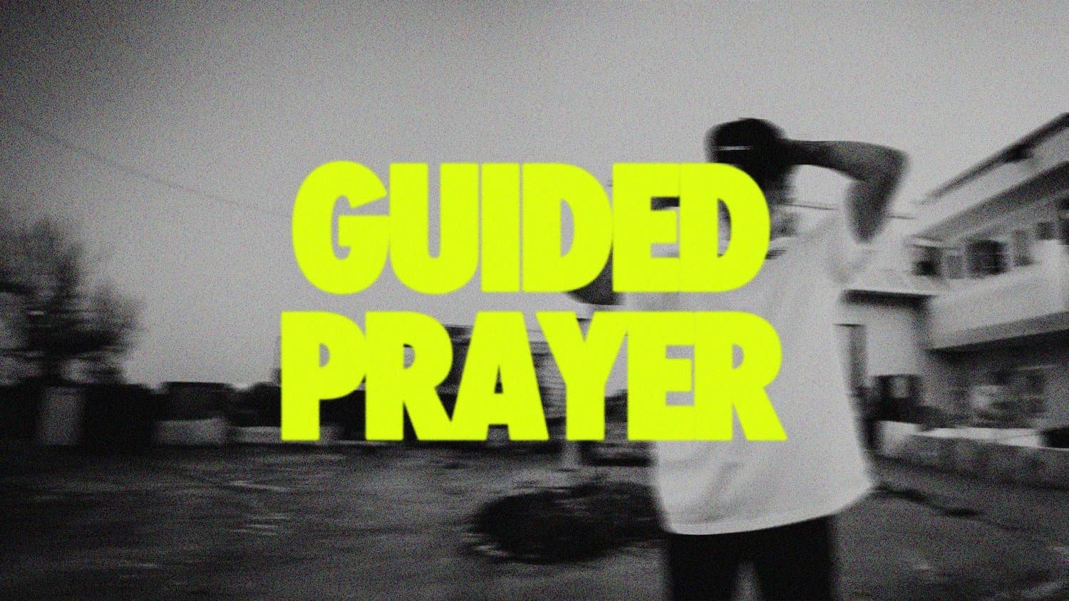 A black and white motion blurred photograph of a person outdoors, overlaid with GUIDED PRAYER in neon yellow condensed capitals.