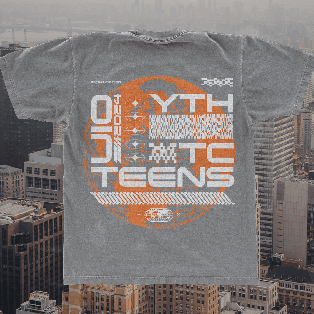 A merch mockup of a washed grey tee over an aerial city view, printed YTH TC TEENS in white techno capitals over an orange wireframe globe and glitch bars.