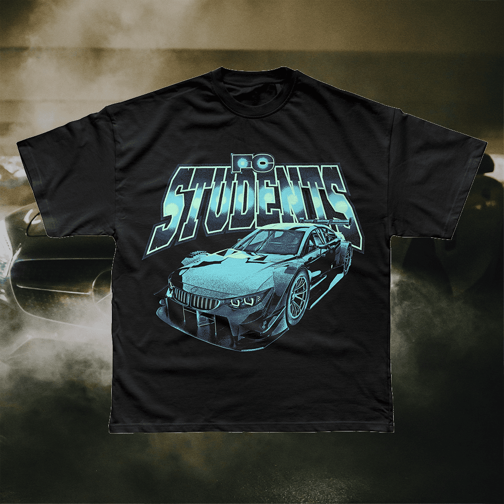 A merch mockup of a black oversized tee over a smoky racetrack, printed FC STUDENTS in chrome capitals above an airbrushed teal race car.