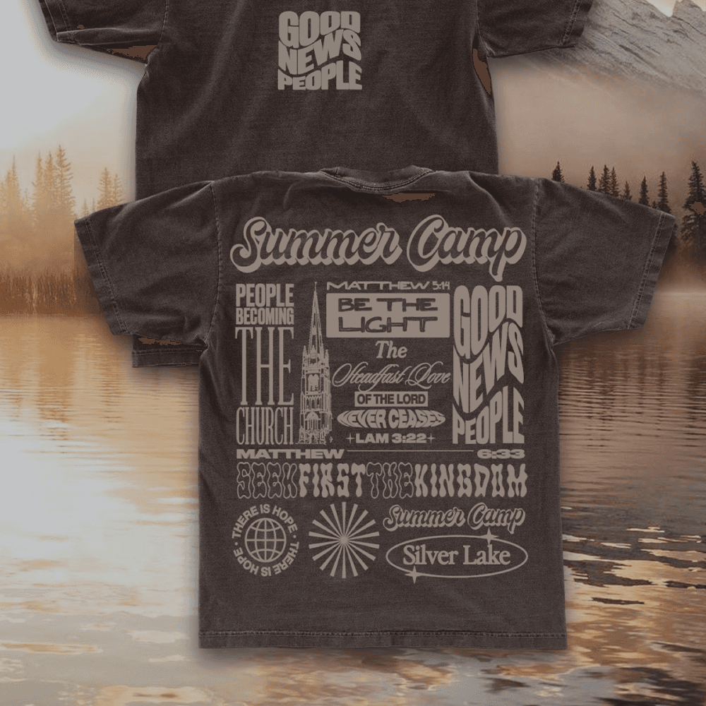 A merch mockup of two washed brown tees over a misty lake, printed Summer Camp in tan with a church spire, SEEK FIRST THE KINGDOM and GOOD NEWS PEOPLE.