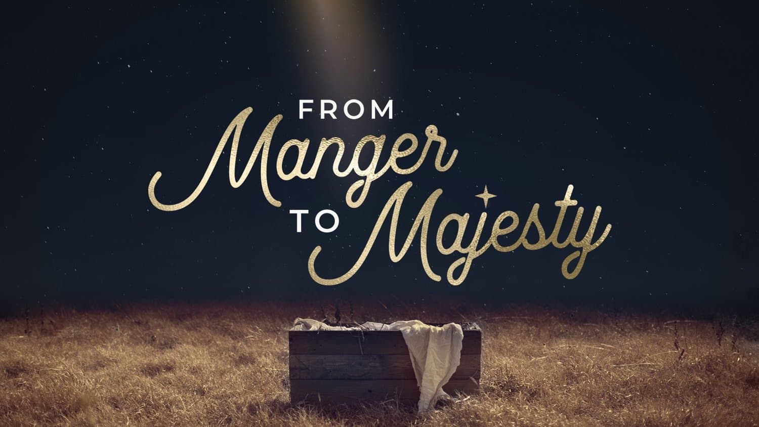 A Christmas series slide reading FROM Manger TO Majesty in gold glitter script, over a night photo of a wooden manger with cloth in a dry field under starlight.
