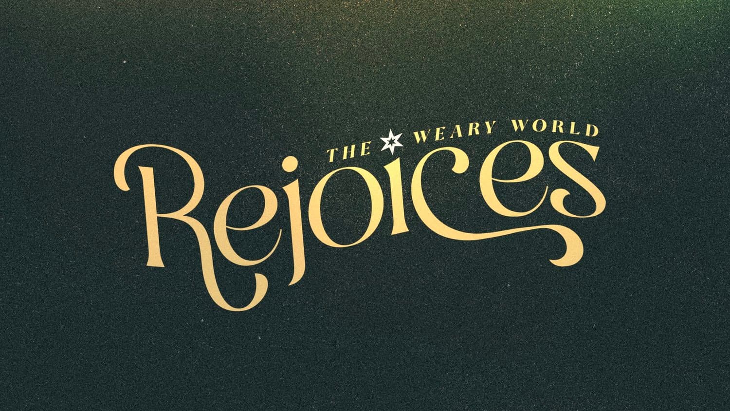 A Christmas slide reading THE WEARY WORLD Rejoices in cream ligatured script on a near black grainy green field, with a small white star.