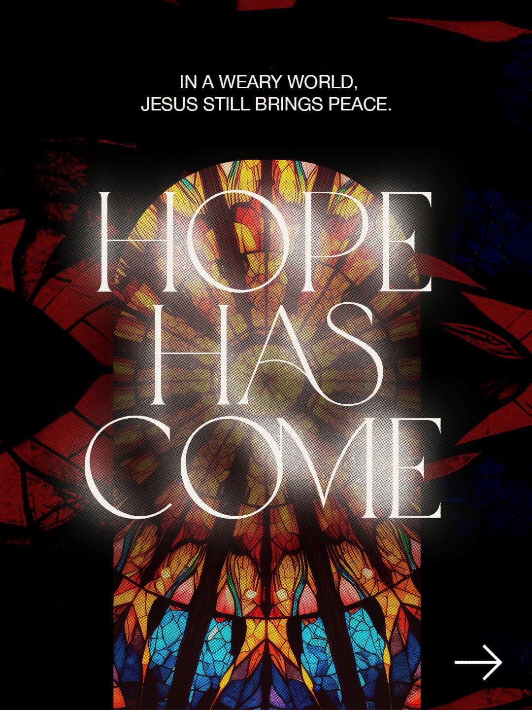 Christmas graphic reading Hope Has Come in glowing serif type over stained glass