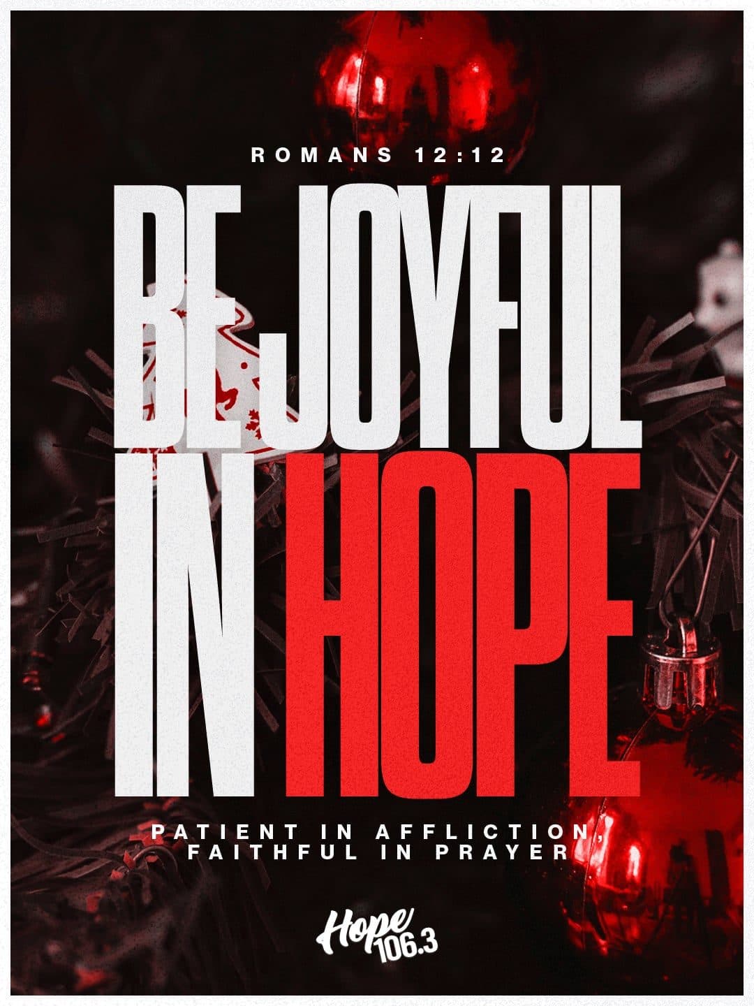 Dark Christmas graphic reading Be Joyful in Hope in bold white and red type over ornaments