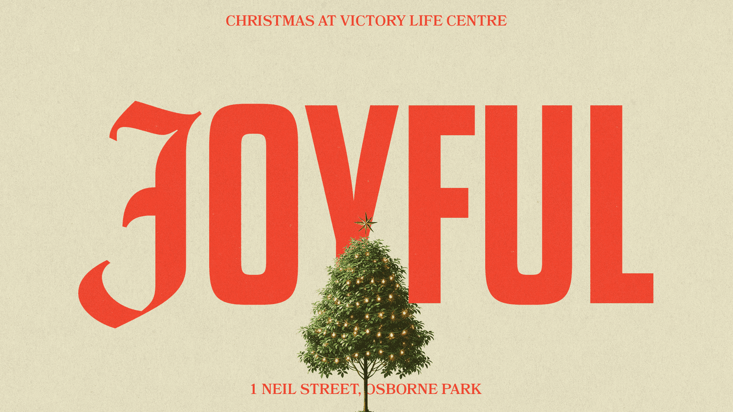 A pale green Christmas slide reading JOYFUL in huge red letters with a blackletter J, headed CHRISTMAS AT VICTORY LIFE CENTRE, with a lit tree standing in the middle and an Osborne Park address.