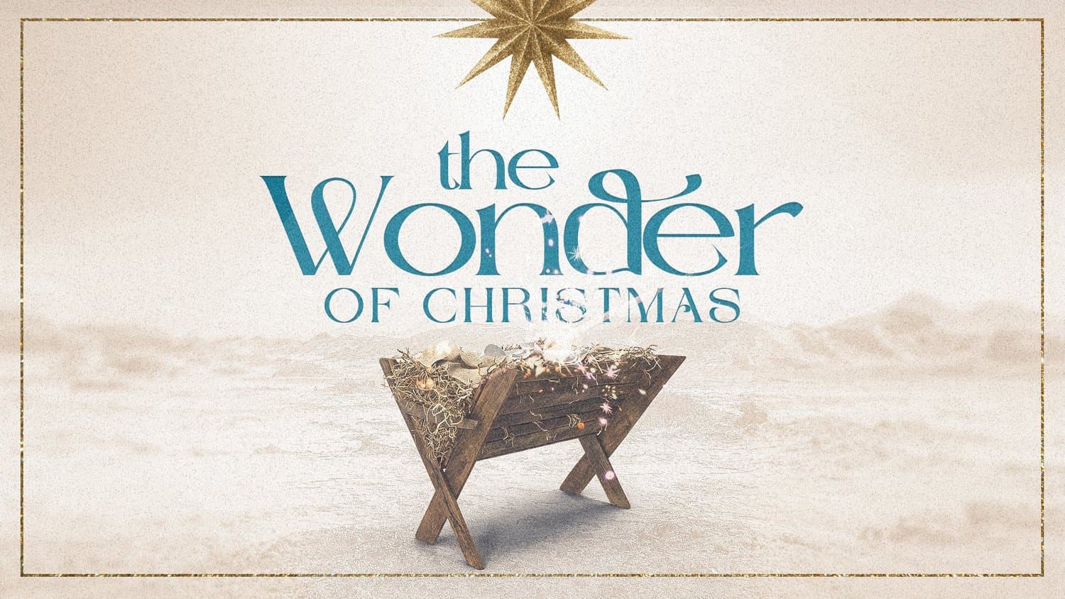 A sand toned Christmas slide reading the Wonder OF CHRISTMAS in teal serif above a wooden manger strung with lights, under a gold glitter star.