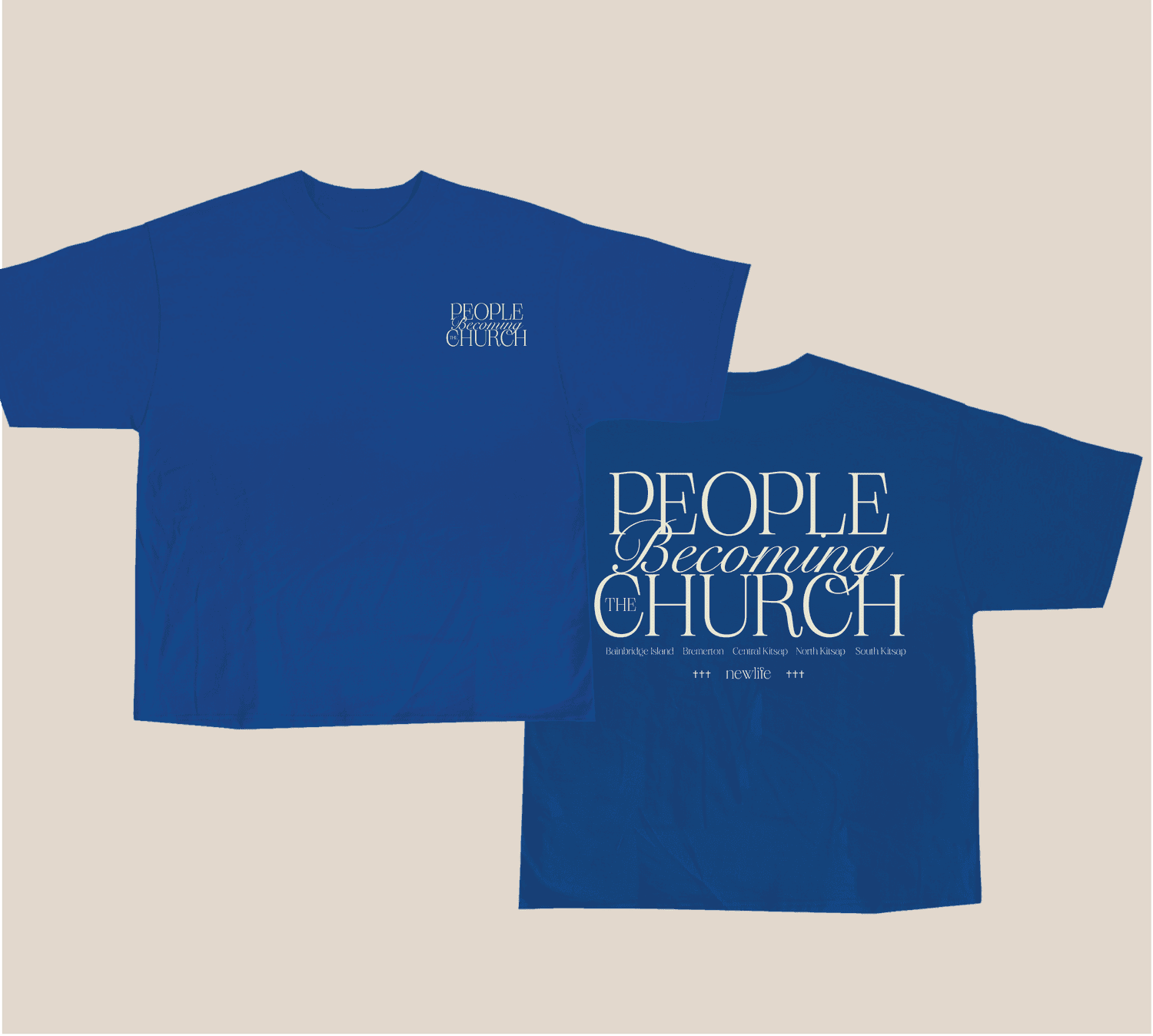 A merch mockup of two royal blue tees reading PEOPLE Becoming THE CHURCH in cream serif and script, listing Bainbridge Island, Bremerton and other Kitsap locations under a newlife mark.