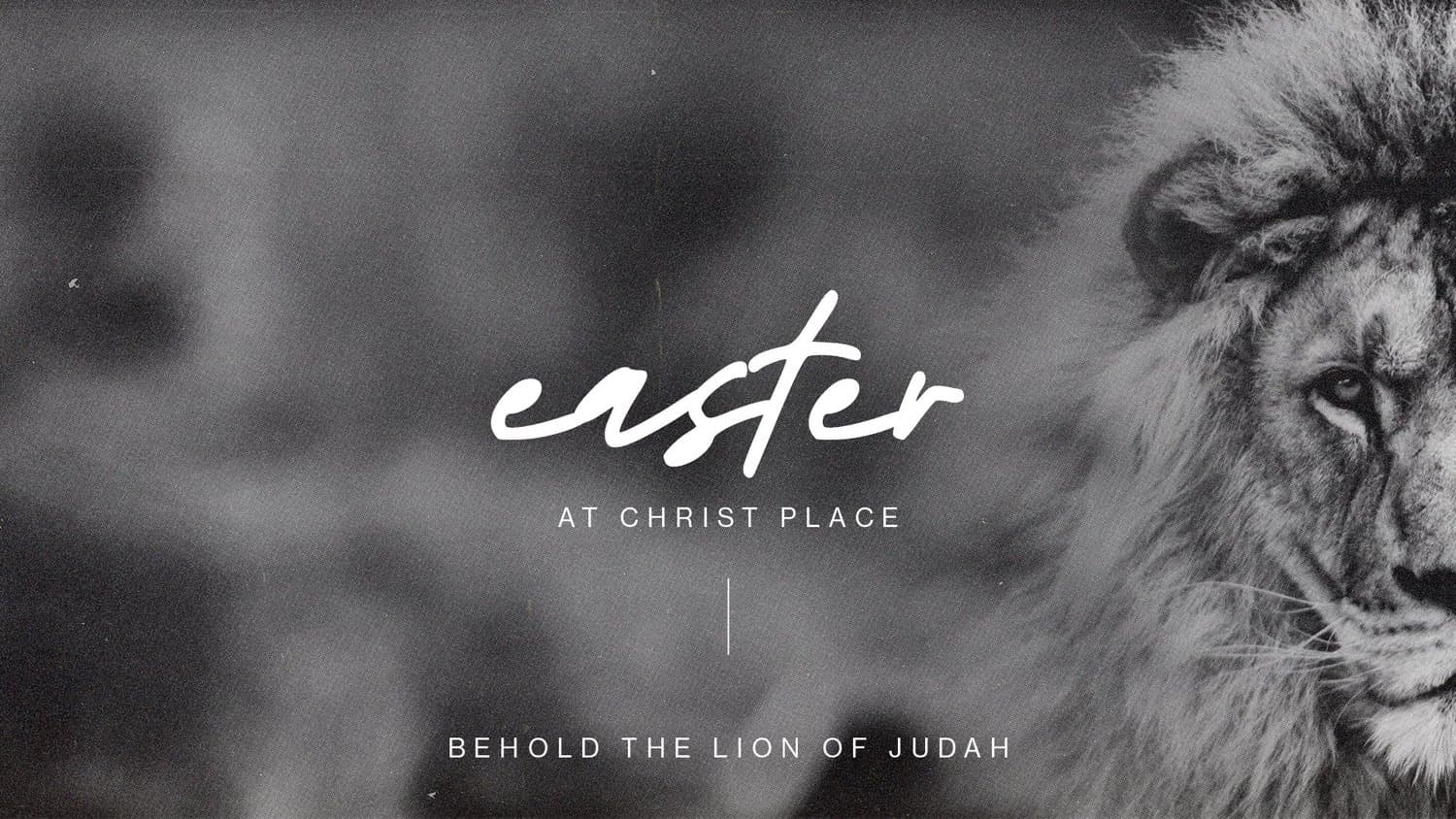 A black and white Easter slide reading easter AT CHRIST PLACE in white script, beside a lion's face, with BEHOLD THE LION OF JUDAH below.