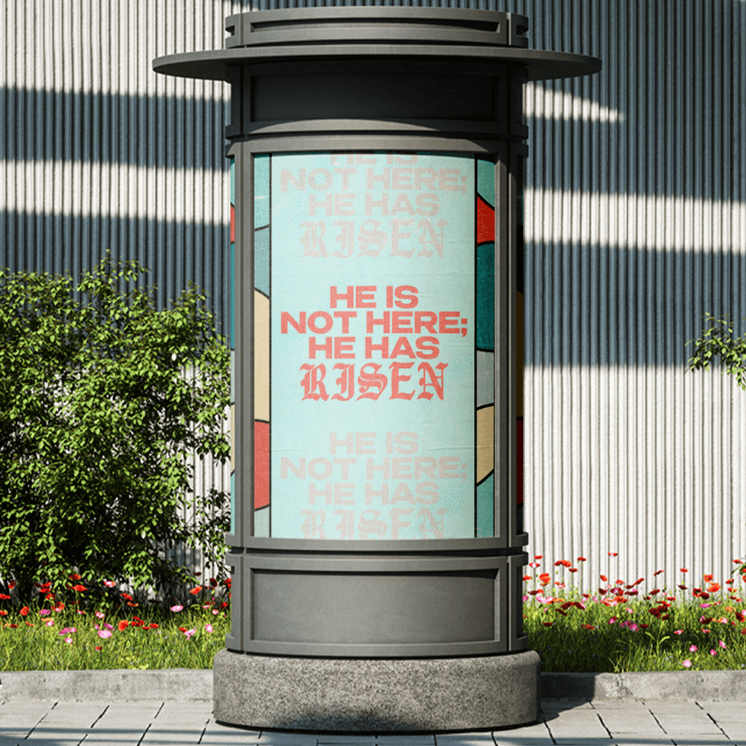 A cylindrical street kiosk poster in mint and coral, repeating HE IS NOT HERE; HE HAS RISEN three times with the middle line solid and the outer two faded.