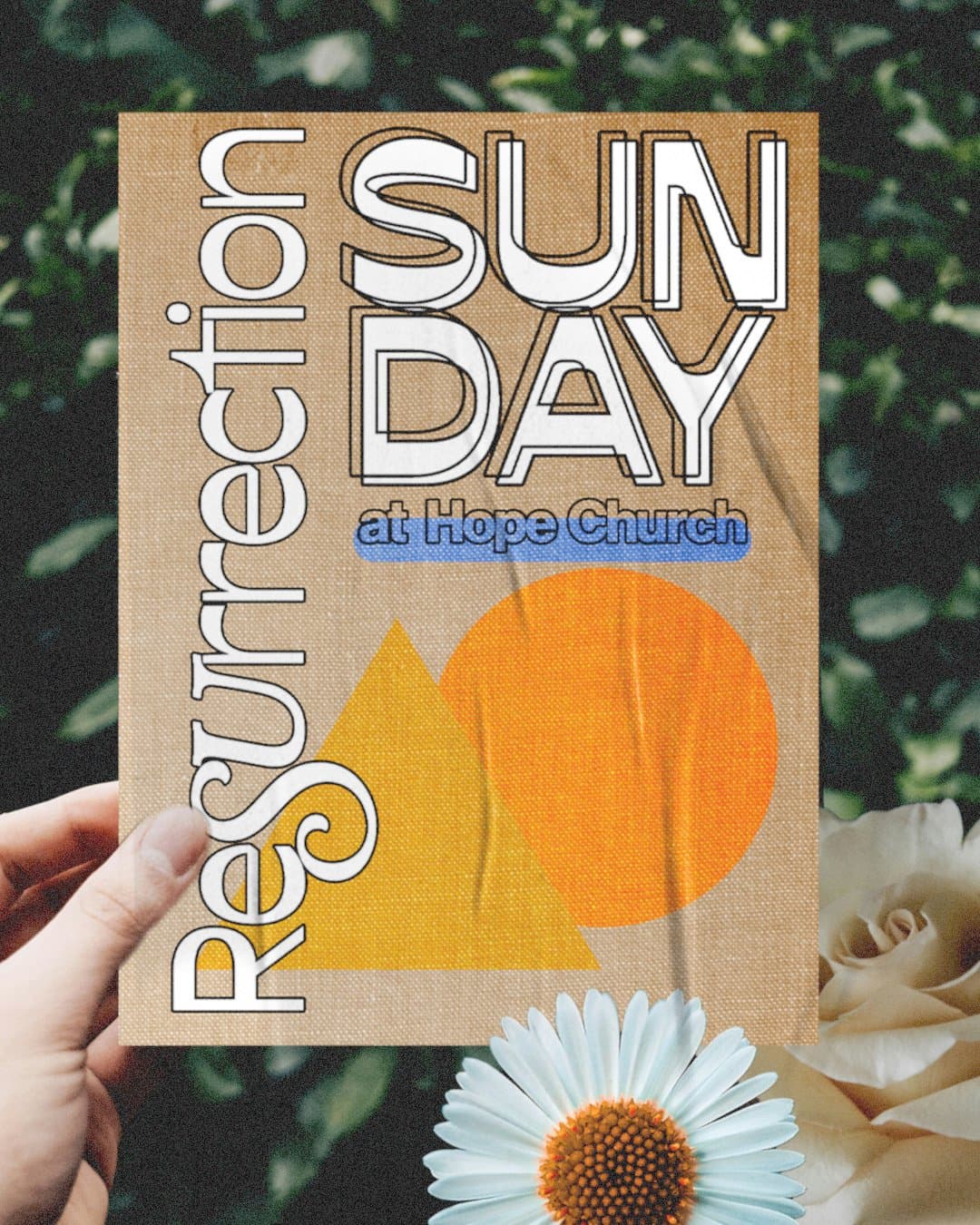 A hand holding a kraft paper Easter flyer reading Resurrection SUNDAY in white outlined type with at Hope Church on a blue bar, over an orange circle and yellow triangle.