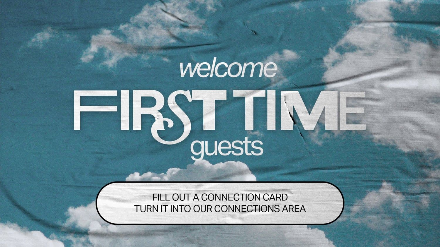 A guest welcome slide reading welcome FIRST TIME guests in white type over a wrinkled poster photo of blue sky and clouds, with a pill button asking guests to fill out a connection card.