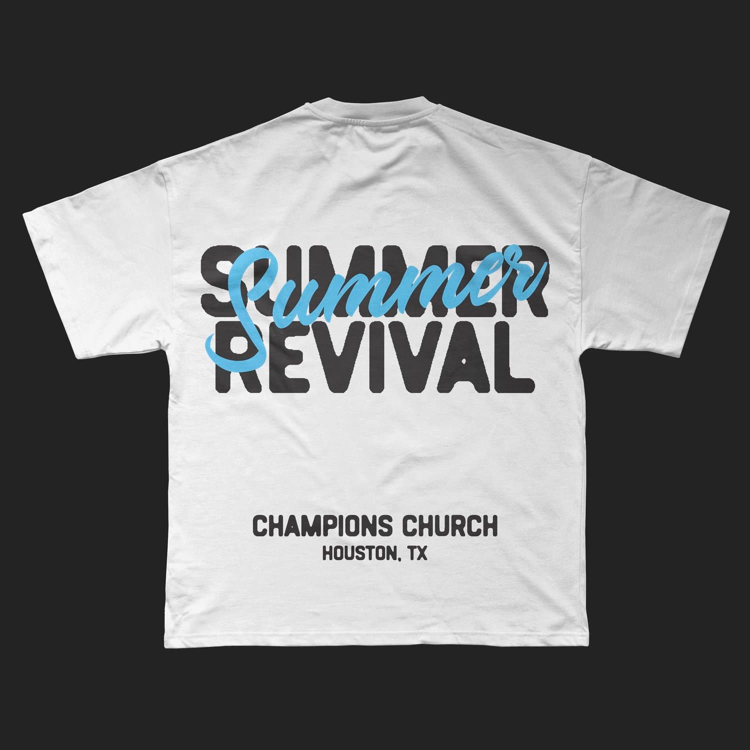 A merch mockup of a white oversized tee printed SUMMER REVIVAL in black block capitals with Summer overlaid in light blue script, above CHAMPIONS CHURCH HOUSTON, TX.