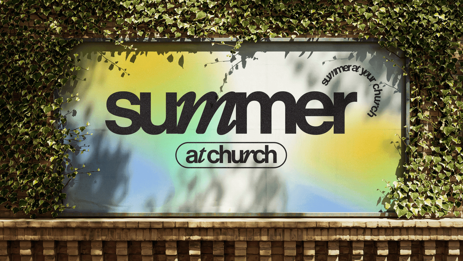 An ivy framed outdoor billboard reading summer in heavy black lowercase over a yellow, blue and green gradient, with at church in an outlined pill and summer at your church curved above.